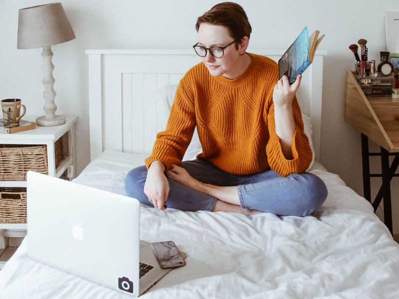a woman on the bed with computer